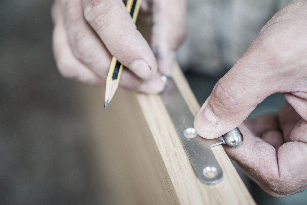 Carpenter working over door edge, shallow depth of field