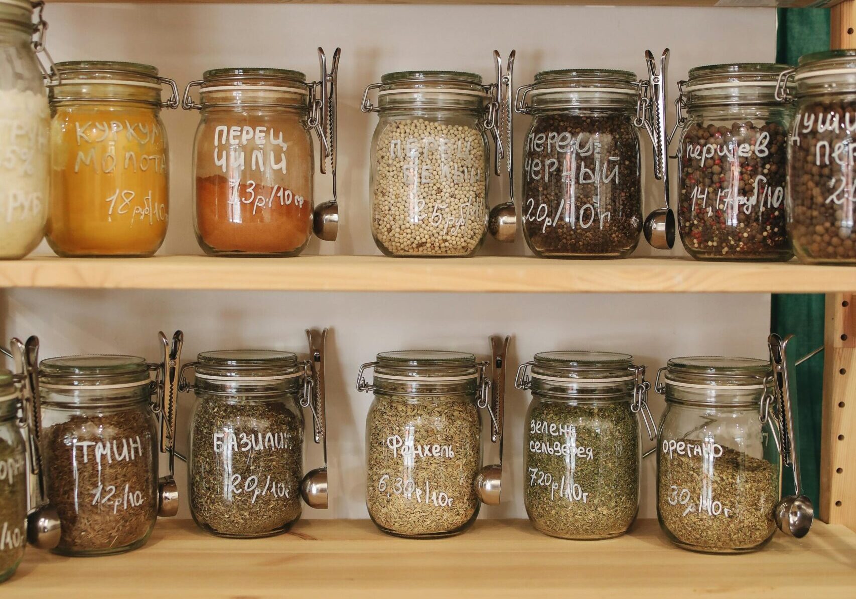 Shelves filled with assorted jars of preserved foods and spices.